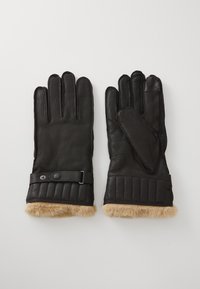 Black leather gloves featuring a quilted cuff, fur lining, and a strap with a snap closure for added fit. Soft texture and streamlined design.