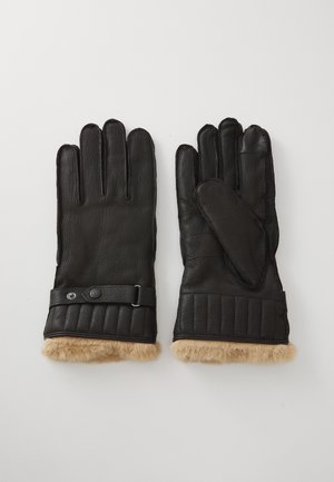 Black leather gloves featuring a quilted cuff, fur lining, and a strap with a snap closure for added fit. Soft texture and streamlined design.