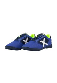 Zapatillas deportivas azules con paneles de malla y acentos blancos. El diseño presenta superficies texturizadas y una suela de goma, populares para deportes en interiores.