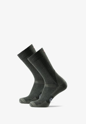 Dunkelgrüne Wollsocken mit gerippter Textur, verstärktem Fersen- und Zehenbereich sowie einem dezenten Logo in der Nähe des Knöchels. Elastischer Bund für einen sicheren Sitz.