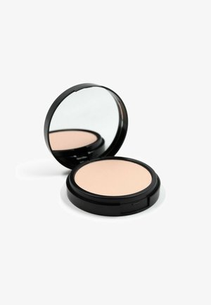Confezione rotonda di cipria compatta nera lucida con specchio, contenente una cipria beige liscia. La superficie esterna è lucida e non presenta motivi visibili.