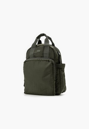 Dark green nylon backpack with padded structure, top handles, adjustable straps, front zipper pocket, and side slip pocket.