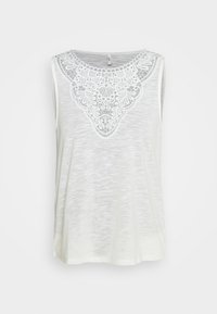 Ärmlös vit topp i texturerad slubbtyg med en intrikat spetsdesign vid halsringningen, som har blommönster och geometriska mönster.