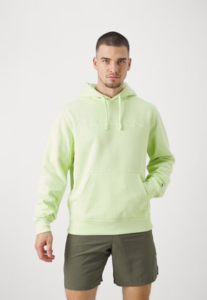 Sudadera verde claro con cordones, bolsillo frontal y logotipo bordado. Hecha de tejido suave, presenta puños y dobladillo de canalé.