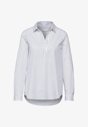 Biała koszula z długim rękawem, w pionowe czarne paski, z kołnierzykiem i lekko zaokrąglonym dołem. Posiada częściowy zapięcie na guziki.