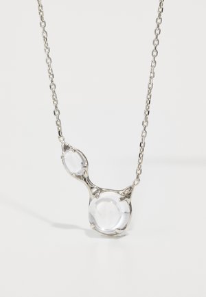 Transparent pendant necklace featuring two round glass beads, set in a silver-tone metal frame with a linked chain.