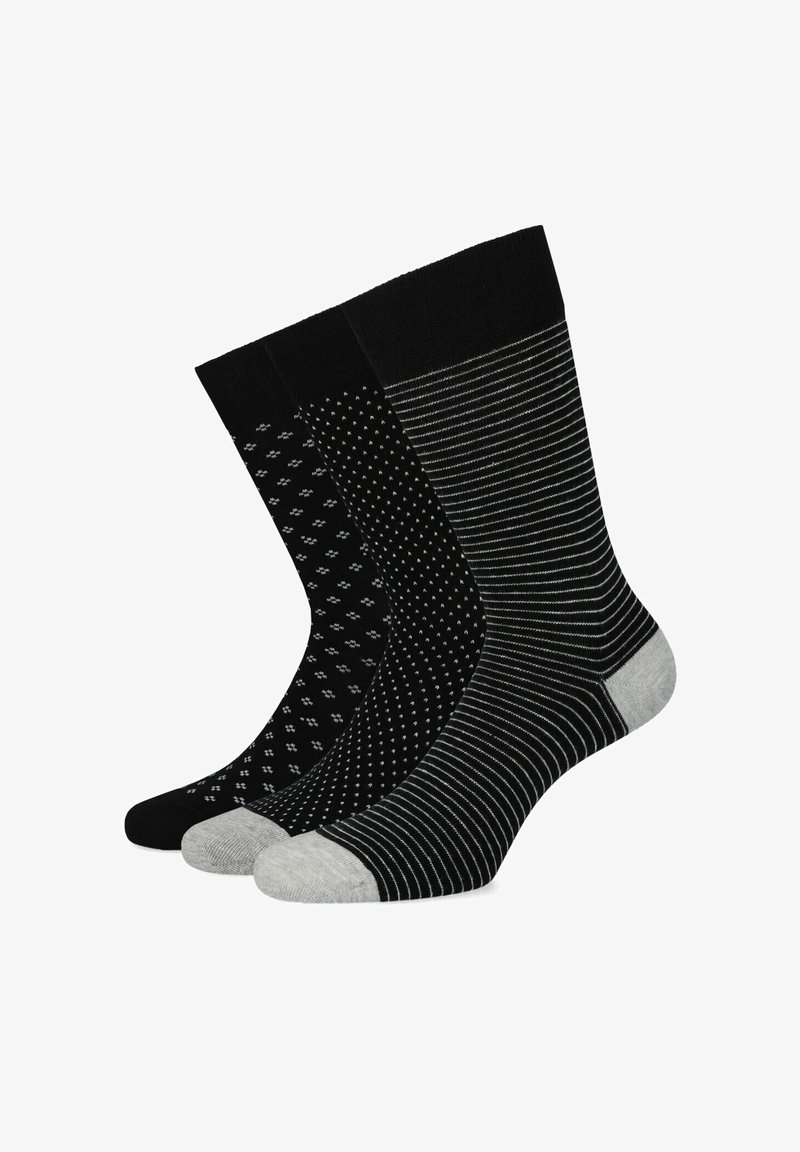 Trzy pary czarnych skarpetek: jedna gładka, jedna w małe białe kropki, a jedna w subtelne szare paski. Wszystkie mają gładką teksturę i różne wzory.