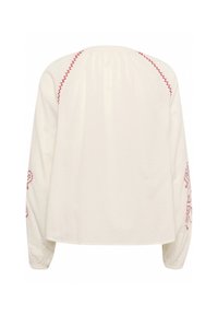 Witte lange mouwen top met rode geborduurde accenten op de mouwen en schoudernaden; heeft een geplooide achterkant voor een ontspannen pasvorm.