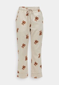 Katoenen loungebroeken in beige met een bedrukt teddybeermotief. Voorzien van een elastische tailleband met een trekkoord en cuffs aan de broekspijpen.