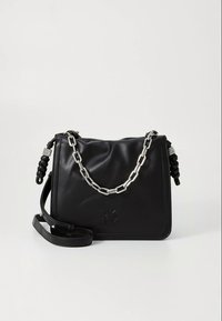 Mala de ombro preta DKNY com alça de corrente prateada, detalhes laterais trançados e alça de couro ajustável sobre um fundo branco liso.