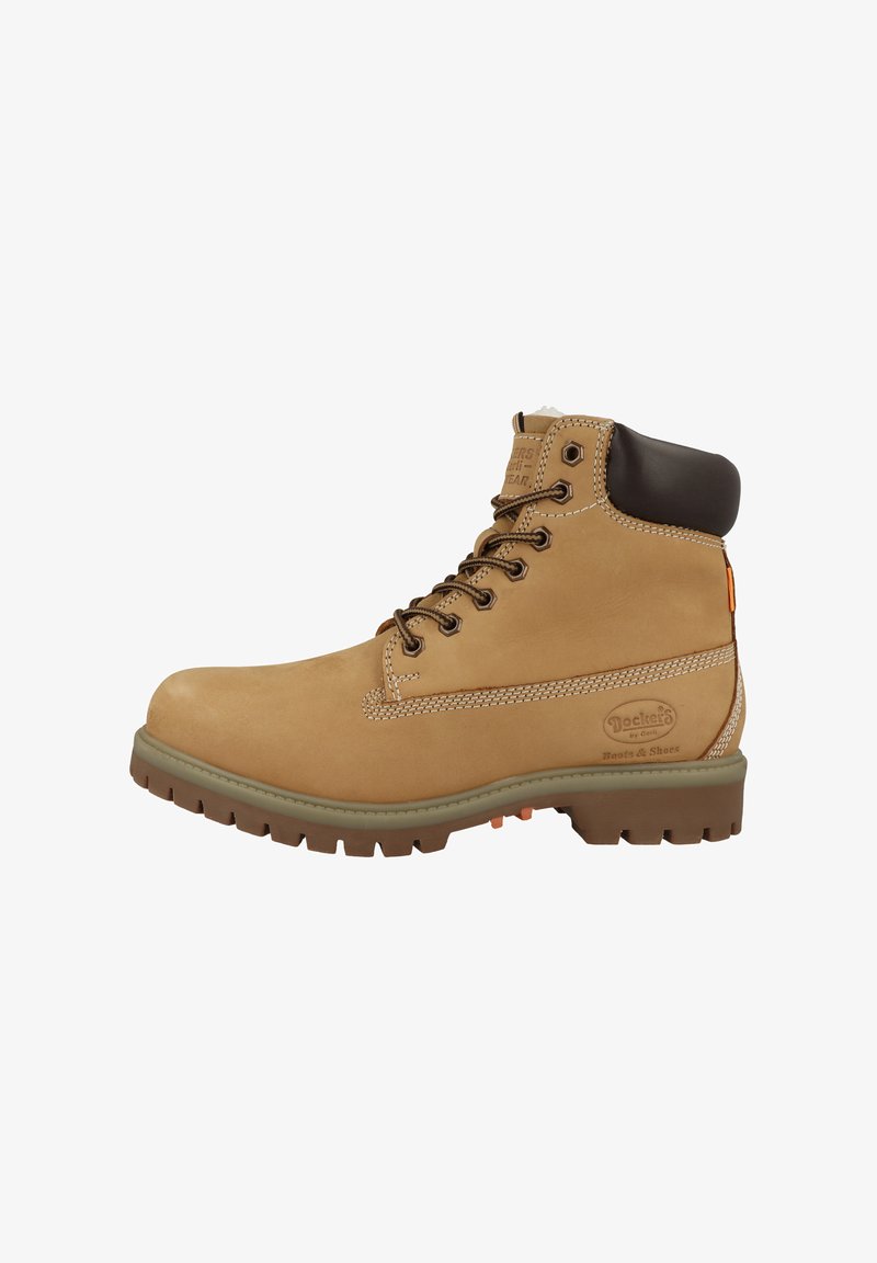 Botas de cuero color coñac con detalles marrones, cuello acolchado y suela de goma gris. Presentan ojales metálicos y detalles de costuras visibles.