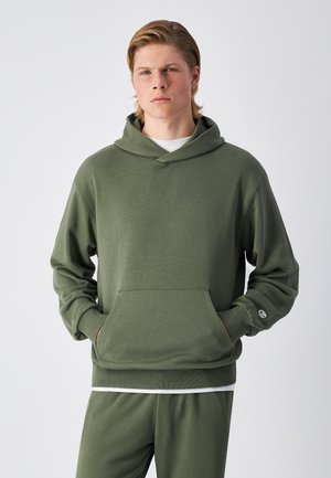Olive green hoodie made of soft fabric, featuring a front pocket, adjustable drawstring hood, and ribbed cuffs. Paired with matching pants.