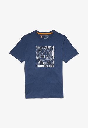 T-shirt a maniche corte blu navy con un grande logo grafico quadrato dell'albero Timberland e testo bianco sul davanti.