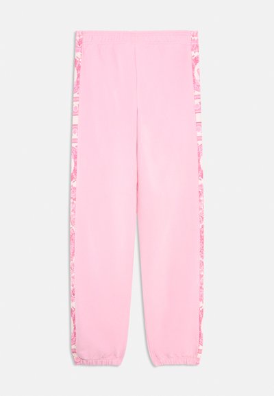 Pantalones de chándal rosa con cinturilla elástica, puños ajustados y paneles laterales que presentan un patrón floral en tonos de rosa y blanco.