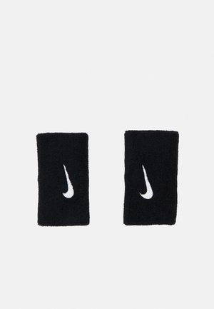 Pulseras de algodón negro con el logotipo de swoosh de Nike bordado en blanco. La textura es suave y absorbente, con forma rectangular.