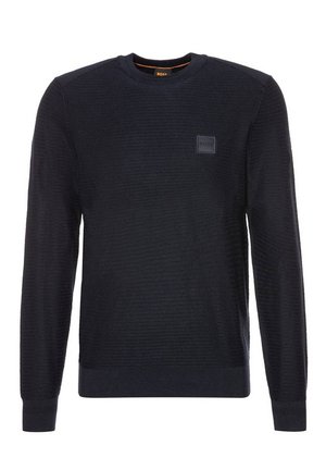 Maglione nero lavorato a maglia con scollatura a girocollo, polsini e orlo a coste, caratterizzato da un patch logo in rilievo sul petto e tessuto testurizzato.