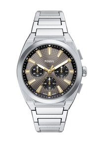 Srebrny zegarek ze stali nierdzewnej z teksturowaną szarym tarczą, złotymi znacznikami godzin i trzema sub-tarczami. Posiada mocny bransoletę ogniwową.