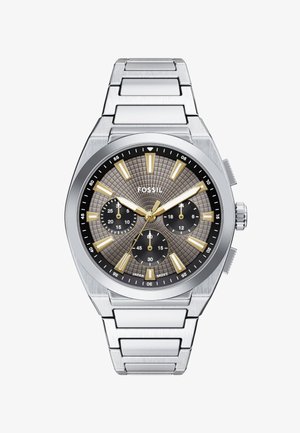 Montre en acier inoxydable argenté avec un cadran gris texturé, des index dorés et trois sous-cadrans. Équipée d'un bracelet à maillons robuste.