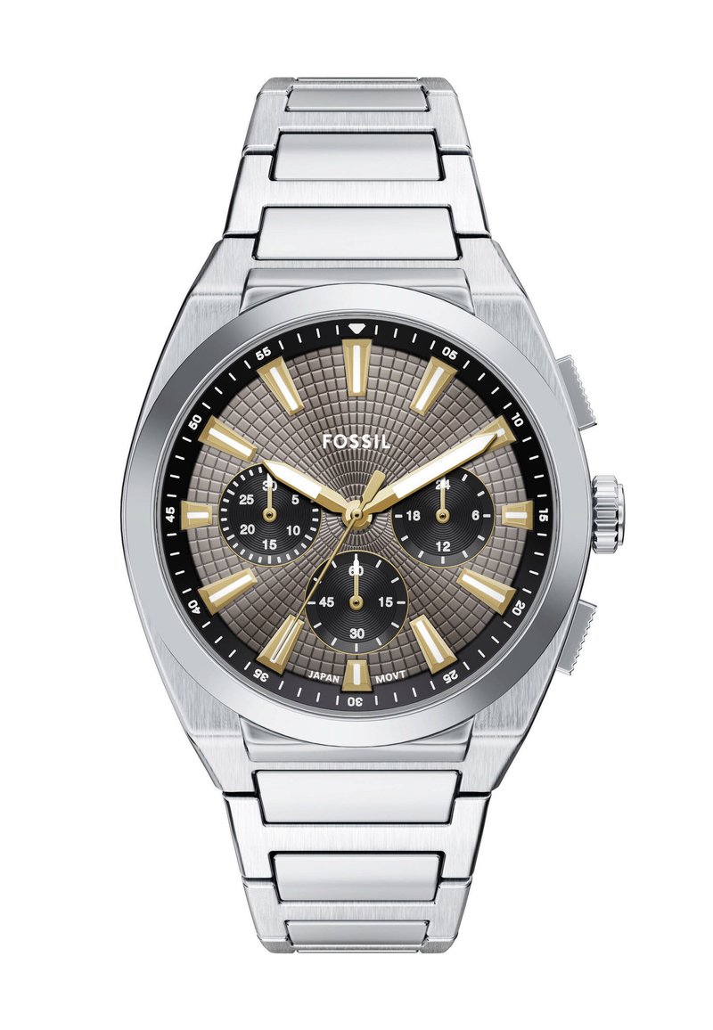 Srebrny zegarek ze stali nierdzewnej z teksturowaną szarym tarczą, złotymi znacznikami godzin i trzema sub-tarczami. Posiada mocny bransoletę ogniwową.