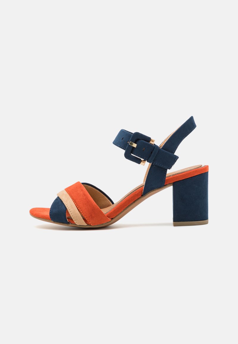 Suede heeled sandal featuring orange, blue, and beige color-blocked straps with an ankle buckle and a sturdy block heel.
