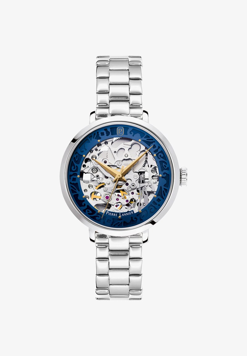 Orologio da polso con cinturino in metallo argentato, ingranaggi interni visibili, anello esterno blu, lancette delle ore e dei minuti dorate, e lancetta dei secondi che indica le 3:24:51.
