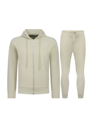 Beige hoodie met volledige rits, trekkoorden en voorzakken, gecombineerd met bijpassende joggingbroek met trekkoorden en boorden.