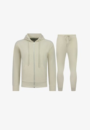 Beige hoodie met volledige rits, trekkoorden en voorzakken, gecombineerd met bijpassende joggingbroek met trekkoorden en boorden.