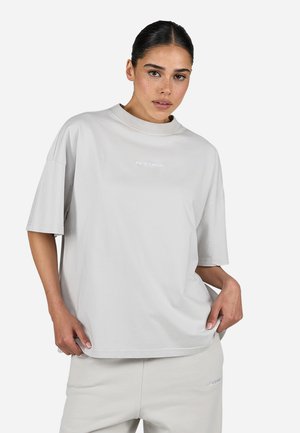 Light gray cotton t-shirt with a relaxed fit, short sleeves, high crew neckline, and embroidered logo detail on the front.