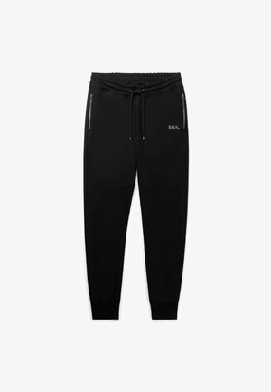 Joggers negros hechos de tela suave y elástica. Cuentan con bolsillos con cremallera, una cintura elástica y puños acanalados. Presentan un branding sutil.