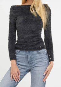 Fuzzy dark gray sweater with an off-the-shoulder design, long sleeves, gathered detailing at the waist, and button accents on the cuffs.