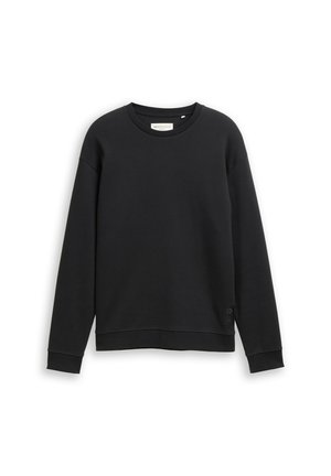 Črna majica s dolgimi rokavi in okroglim ovratnikom, ribane teksture. Ima majhno oznako blagovne znamke na spodnjem levem robu.