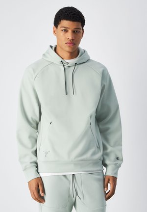 Sudadera con capucha de color verde claro, con cordones negros, mangas raglán, bolsillos tipo canguro y un pequeño logo en la manga. Material texturizado.