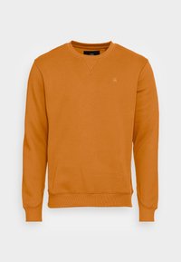 Oranžová mikina vyrobená z texturovaného materiálu. Má kulatý výstřih, pružné manžety a malé logo na hrudi.