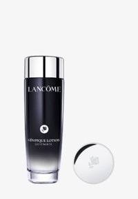 Botella de vidrio negra degradada con tapa plateada, etiquetada como "Lancôme Génifique Lotion Ultimate". Incluye una tapa redonda plateada con un diseño floral.