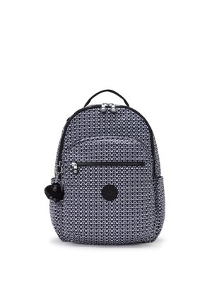 Backpack in navy blue fabric with white geometric pattern. Features two zippered compartments, a side pocket, and a black pom-pom accessory.
