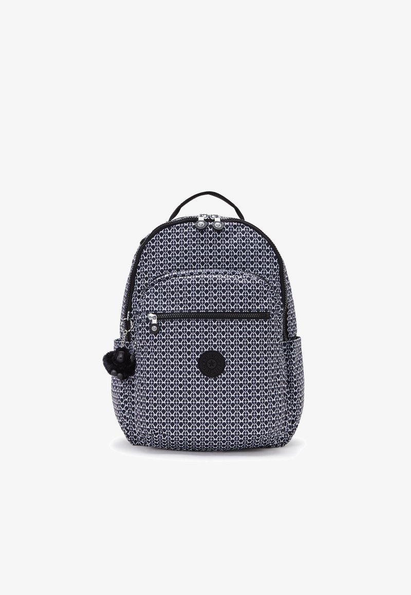 Backpack in navy blue fabric with white geometric pattern. Features two zippered compartments, a side pocket, and a black pom-pom accessory.