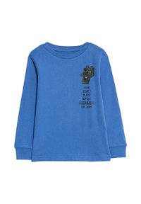 Camiseta de manga larga azul hecha de algodón, que presenta un gráfico temática de Minecraft en el pecho con texto y un diseño de personaje cuadrado.