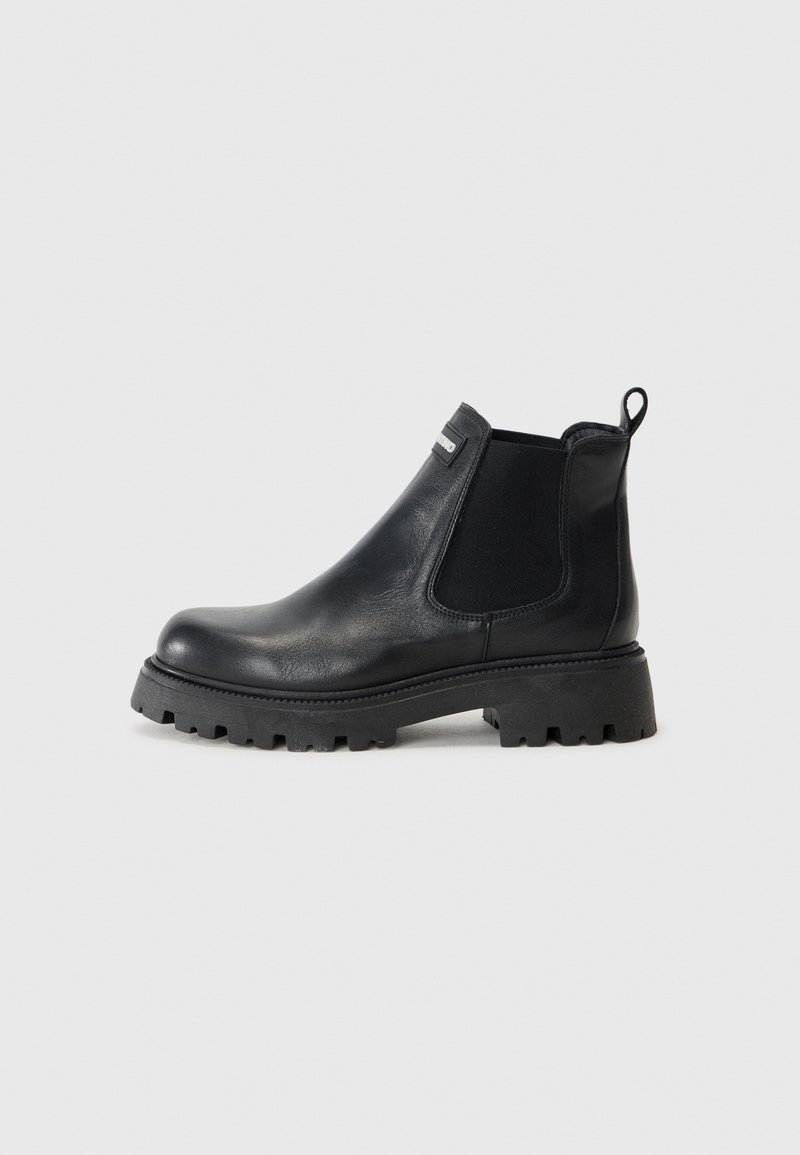 Black leather ankle boot with elastic side panels, rounded toe, and chunky textured sole. Features a pull tab on the back.