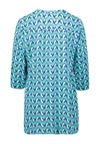 Blauwe en groene gebloemde blouse met driekwart mouwen, een ronde halslijn en een losse pasvorm. Het ontwerp bevat overlappende golfvormen.
