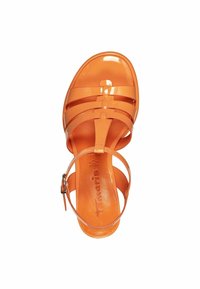 Orange, glossy, strappy sandal made of flexible material. Features ankle strap with buckle and a smooth, flat sole.