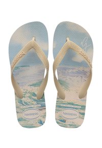 Havaianas flip-flopit, joissa on kermansävyiset hihnat ja tekstuuritalppien sinivalkoinen merikuvio. Koot 37-38 ja 39-40 ilmoitettu.