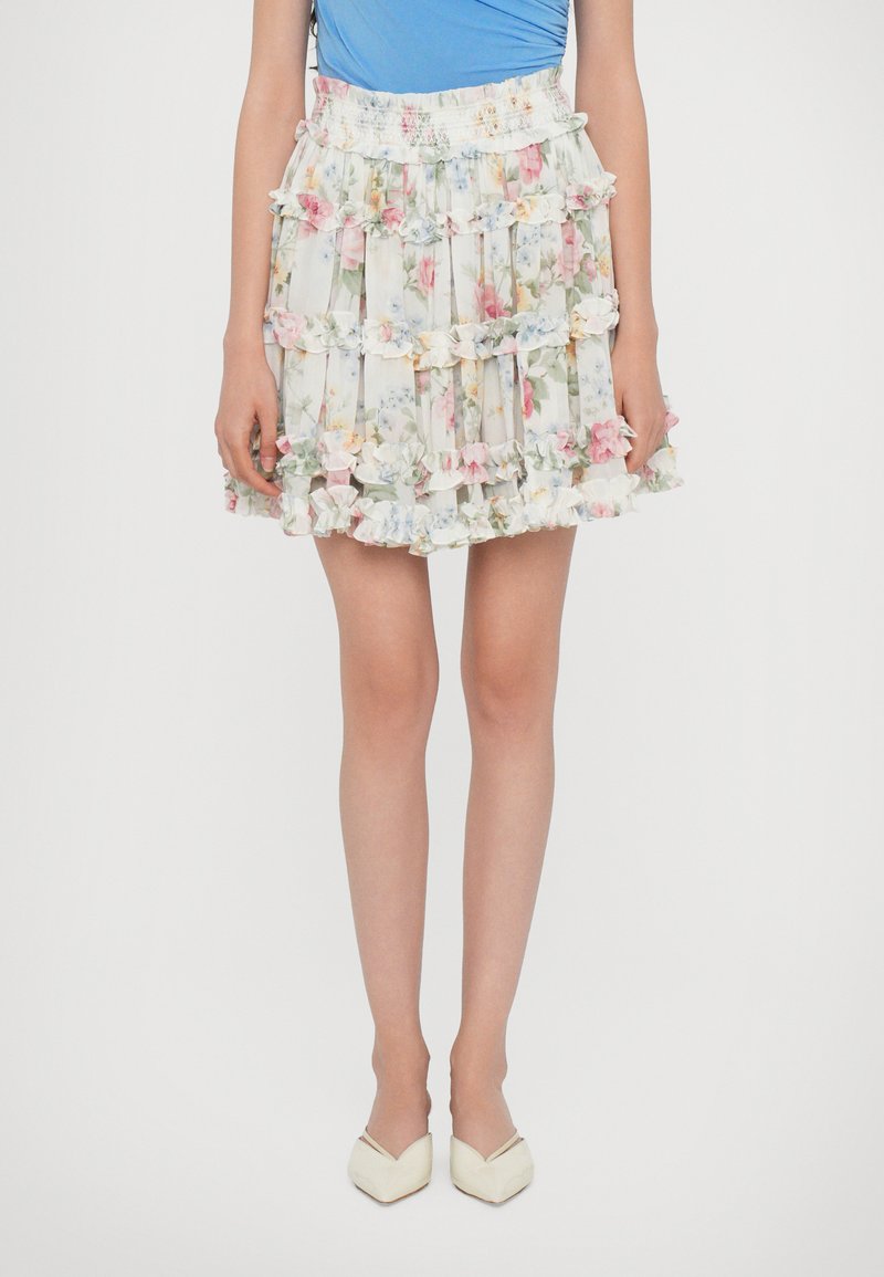 Floral tiered skirt featuring ruffles, pastel colors, and an elastic waistband. The fabric is lightweight with a delicate texture.