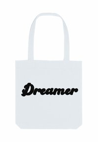 Witte katoenen draagtas met opvallende zwarte tekst die "Dromer" leest in een gestileerd, golvend lettertype. Eenvoudig en functioneel ontwerp.