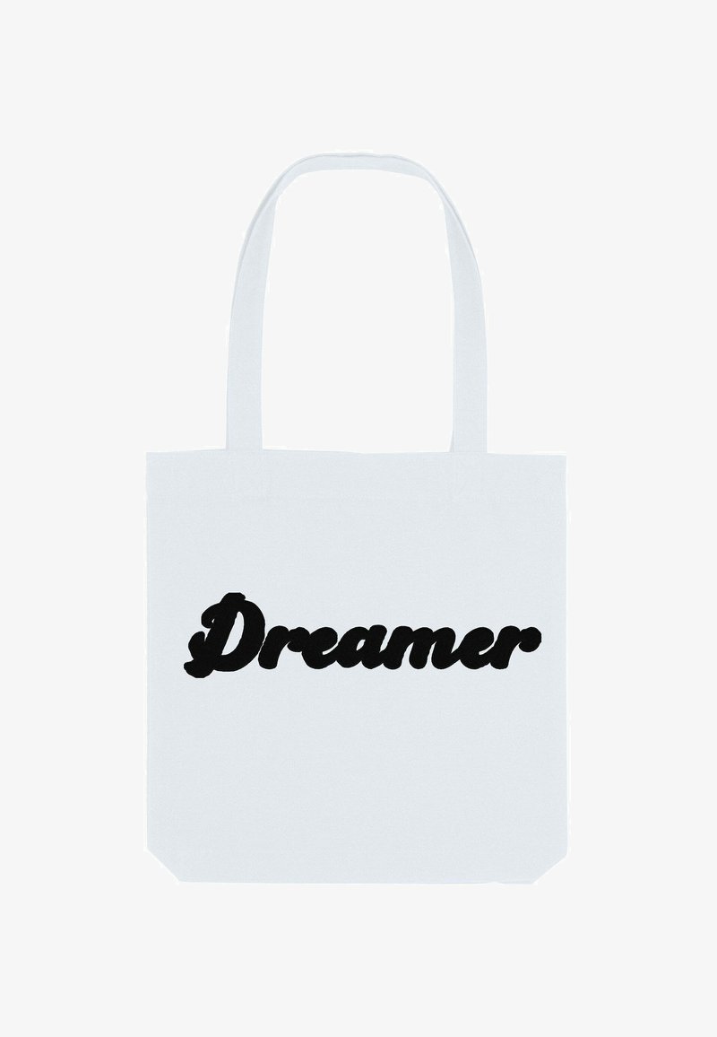 Borsa tote in cotone bianco con testo nero in grassetto che recita "Dreamer" in un font stilizzato e curvo. Design semplice e funzionale.