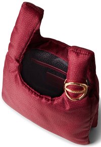 Red textured handbag with a padded design, open top, and gold hardware accent. Interior features a zip pocket and a branded tag.