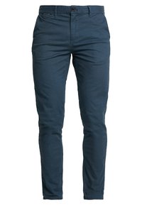 Ciemnoniebieskie spodnie slim-fit wykonane z bawełny, z zapięciem na guzik, szlufkami na pasek oraz przednimi kieszeniami o gładkiej fakturze.