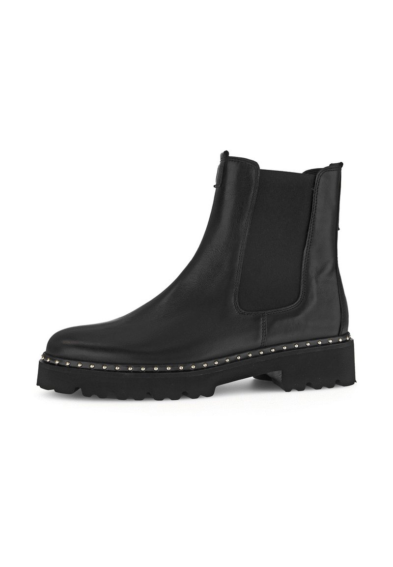 Bottes noires en cuir à cheville avec panneaux élastiques sur les côtés, bout rond et semelle plateforme chunky ornée de petites clous métalliques.