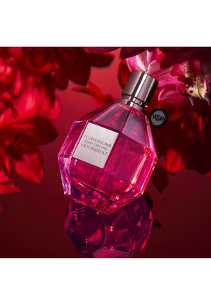 Pink crystal bottle of Flowerbomb Ruby Orchid by Viktor&Rolf, featuring a silver label and rounded, faceted design with reflective surface.