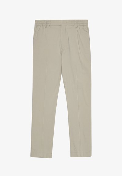 Beige Stoffhose aus weichem Material, mit elastischem Bund, flachem Vorderteil und seitlichen Taschen. Gerades Bein mit sauberen Nähten.