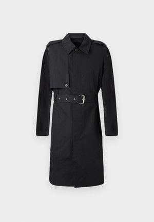 Black knee-length trench coat with belt, buttoned flap on right chest, and shoulder epaulets, displayed on white background.